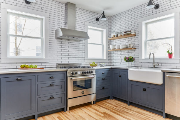 blue gray cabinets combined with concrete countertops in a lovely kitchen