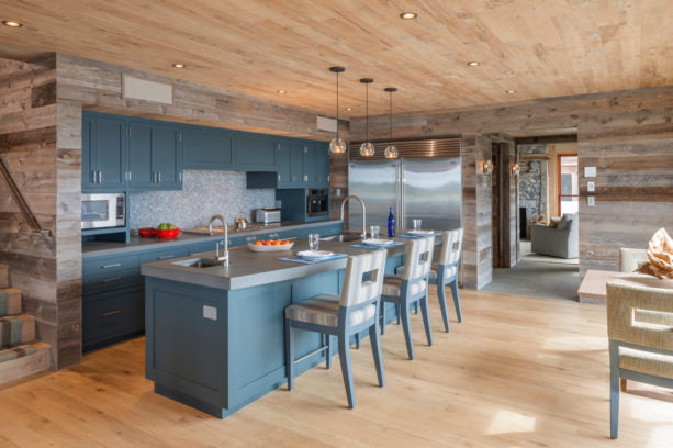 blue gray cabinets with bluestone countertops in a modern rustic kitchen