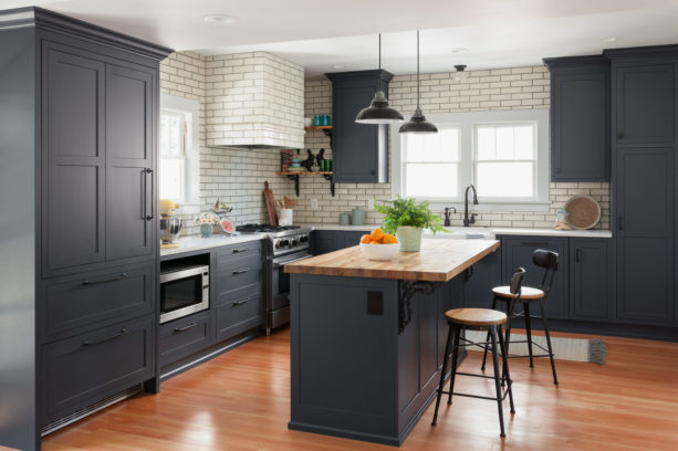 blue gray shaker kitchen cabinets with beige backsplash