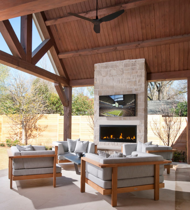 contemporary limestone covered patio with linear firebox fireplace