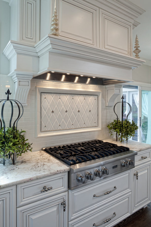 diamond shaped white tile with silver lining backsplash behind stove only