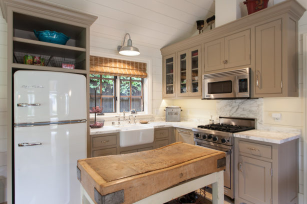 double hung windows over a farmhouse sink in a small kitchen