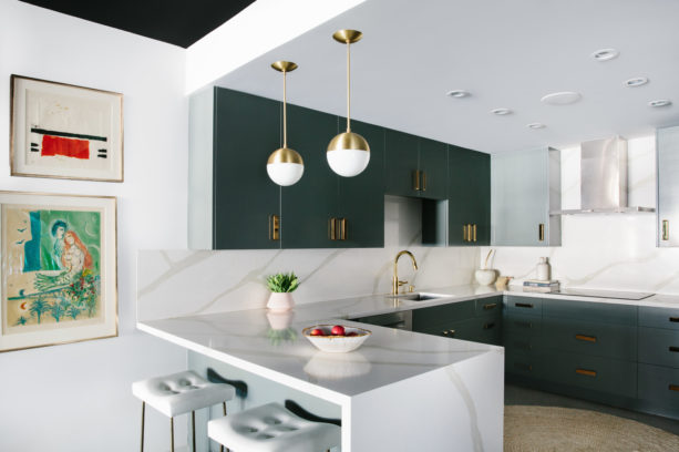 green kitchen cabinets and a peninsula with calacatta gold countertop in a u-shaped layout