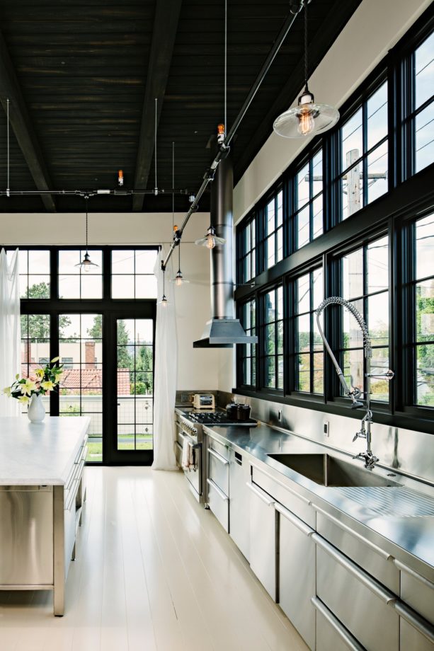 industrial kitchen with an integral sink and wide picture windows over