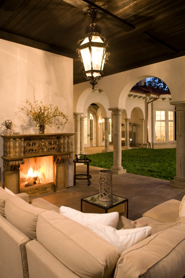 mediterranean concrete covered patio with old antique surround fireplace