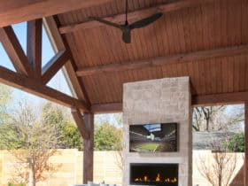 modern patio with outdoor gas fireplace and wall mounted tv