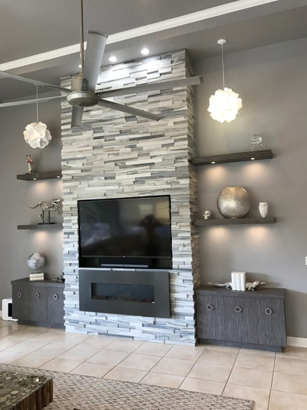 modern wall media unit with fireplace surrounded by cut marble stone