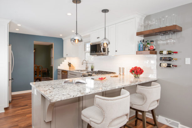 multicolored quartz countertops kitchen peninsula with modern upholstered stools seating
