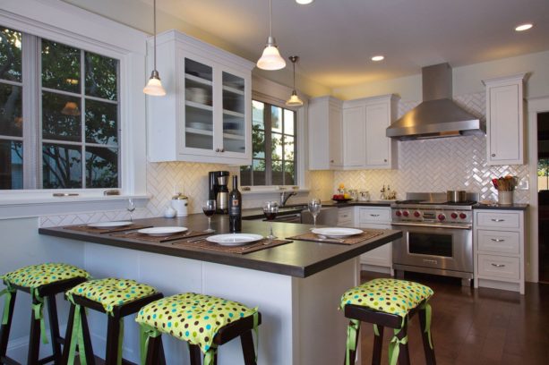 paper stone countertops kitchen peninsula with covered wood barstools seating