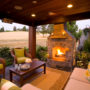 slate carpeted covered patio with fieldstone fireplace
