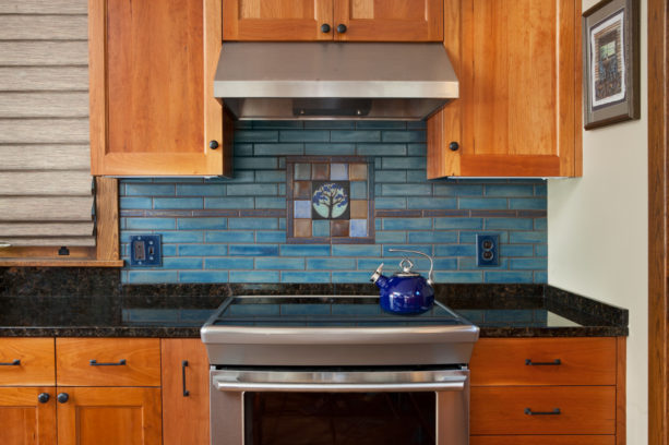 tile mural backsplash only behind stove in a craftsman kitchen