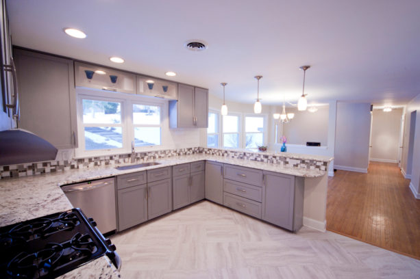 u-shaped contemporary kitchen with granite countertops and a peninsula