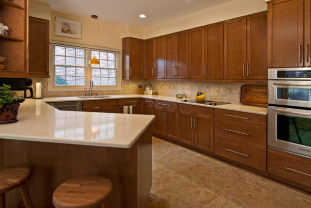 beige floor and sherwin williams “cachet cream” kitchen color combined with brown shaker cabinets for a nice and warm look