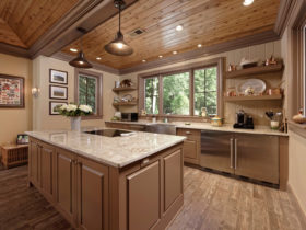 beige kitchen color mixed with light brown raised-panel cabinets to achieve a homey feeling