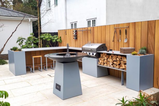contemporary l-shaped outdoor garden kitchen with wood burning barbecue