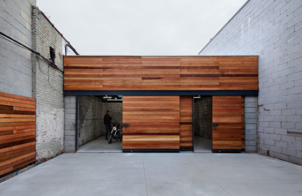 garage with cherry side sliding door and stacked exposed concrete blocks