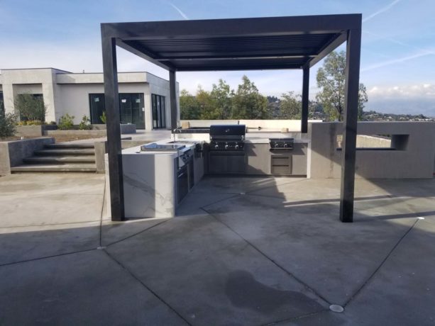 l-shaped modern design outdoor patio kitchen covered with dark metal structure