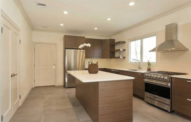 medium tone wood brown flat-panel cabinets with white backsplash to create a perfect harmony