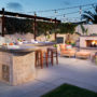 tropical l-shaped outdoor kitchen patio completed with a gas fireplace