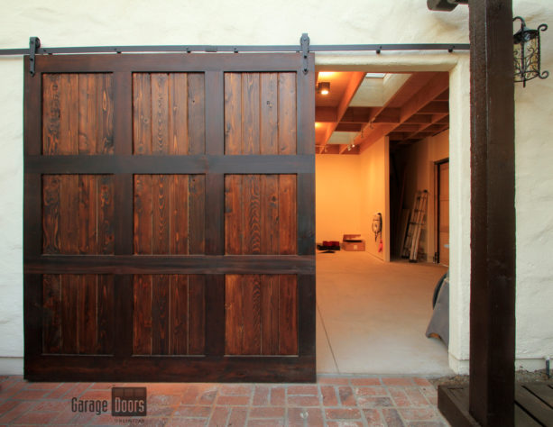 wood side sliding garage door with overhead steel decor