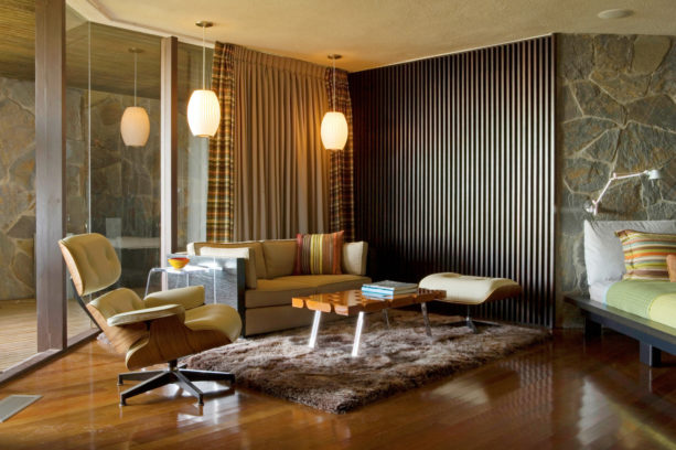 1950s family room with medium tone floor and dark tone vertical wood slat wall