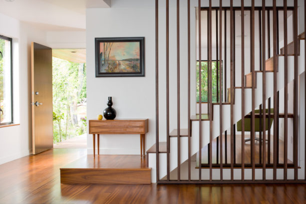 contemporary staircase with dark brown vertical wood slat wall