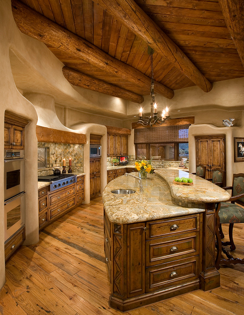 https://aprylann.com/wp-content/uploads/2021/09/curvy-two-level-kitchen-island-made-of-dark-toned-wood.jpg