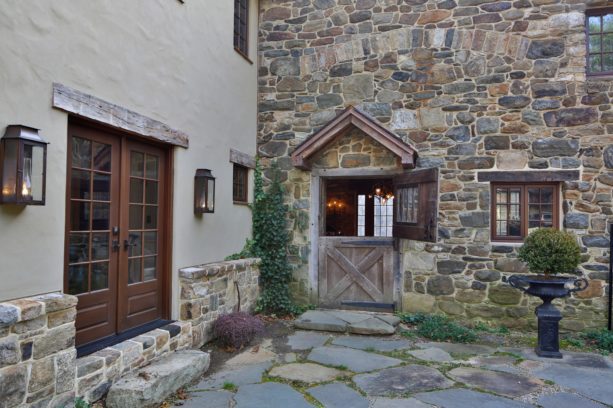 dutch door in an exterior barn design as a side entrance of a country stone house