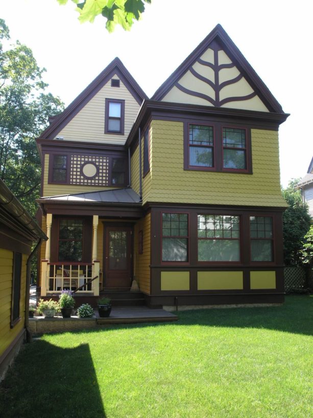 fun and bright light green house with yellow paint and mocha brown trim