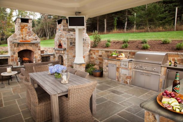 l-shaped bucks county blend stone fireplace and a pizza oven