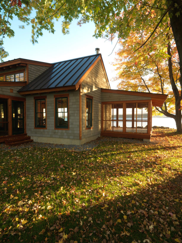 lake cottage green house with metal roof and brown trim