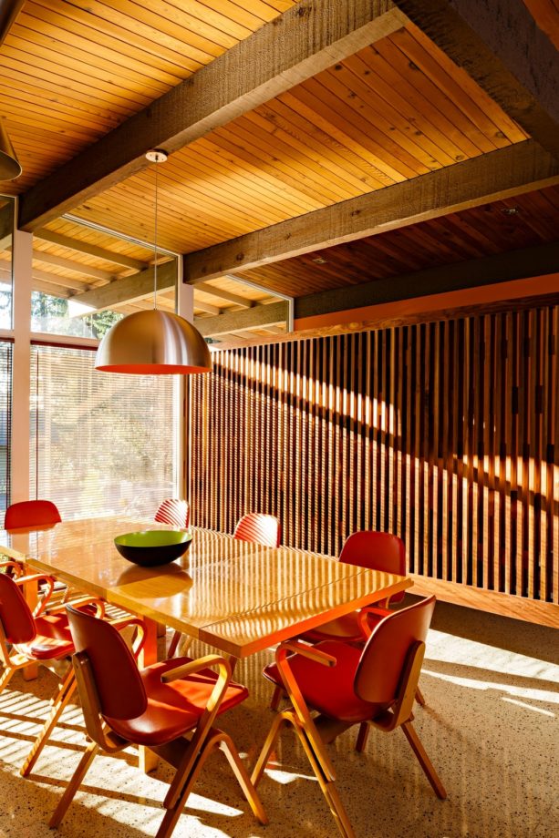 mid-sized 1960s dining room with vertical wood slat wall as a screen
