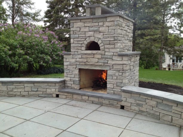 outdoor stone fireplace with built-in pizza oven