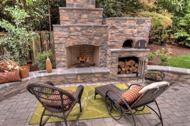 three-tiered outdoor fireplace with a wood-burning pizza oven on its side