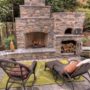 three-tiered outdoor fireplace with a wood-burning pizza oven on its side