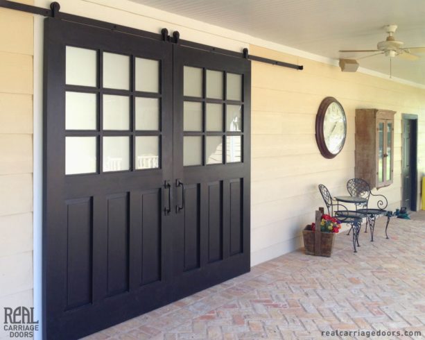 wood sliding exterior barn door in a traditional patio