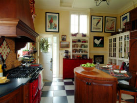 combination of black and white tile kitchen floor with the cherry wood element