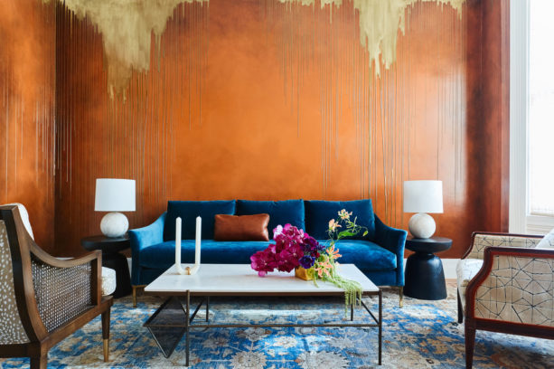 custom finish bronze orange wall mixed with navy blue sofa in a mid-sized living room
