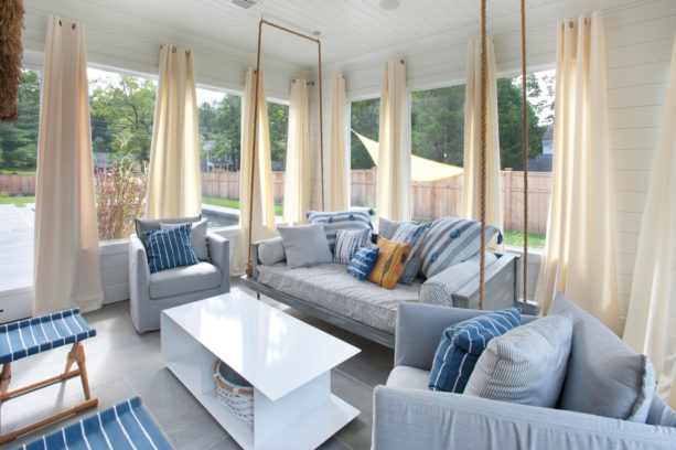 extended a living space by enclosing a porch with curtains