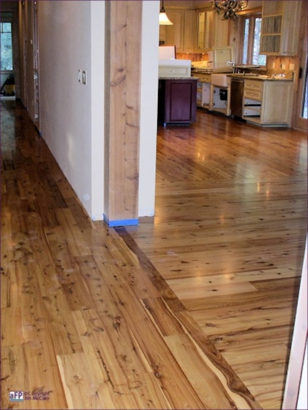 laminate wood floors in different patterns in the adjoined hallway and den room