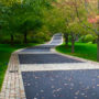 mix of belgian porphyry squares, reclaimed curbing, and european sandstone to widen a driveway