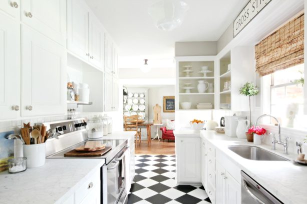 vct checkerboard black and white floor in an all-white kitchen