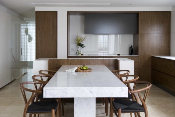 carrera marble dining table against the low wooden wall