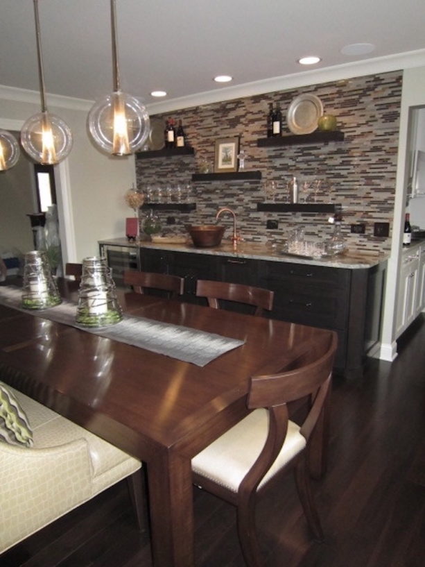 combination of the stylish dining room and wet bar with floating shelves