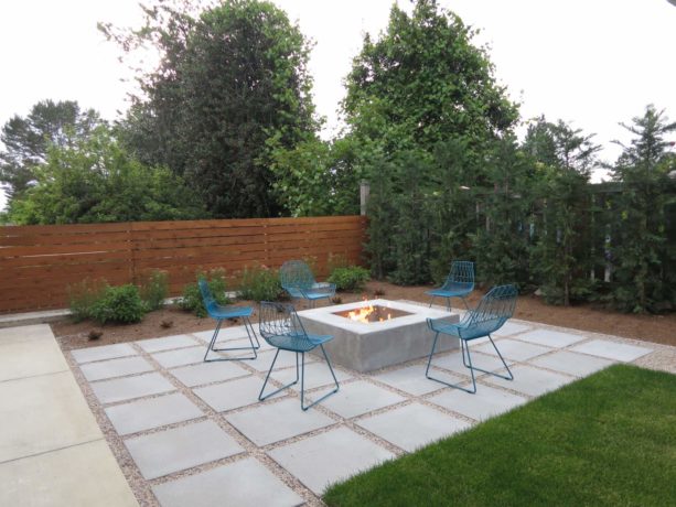 contemporary small backyard with a fire pit and paved with concrete