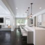 dark distressed maple engineered wood floor combined with white kitchen cabinets and backsplash