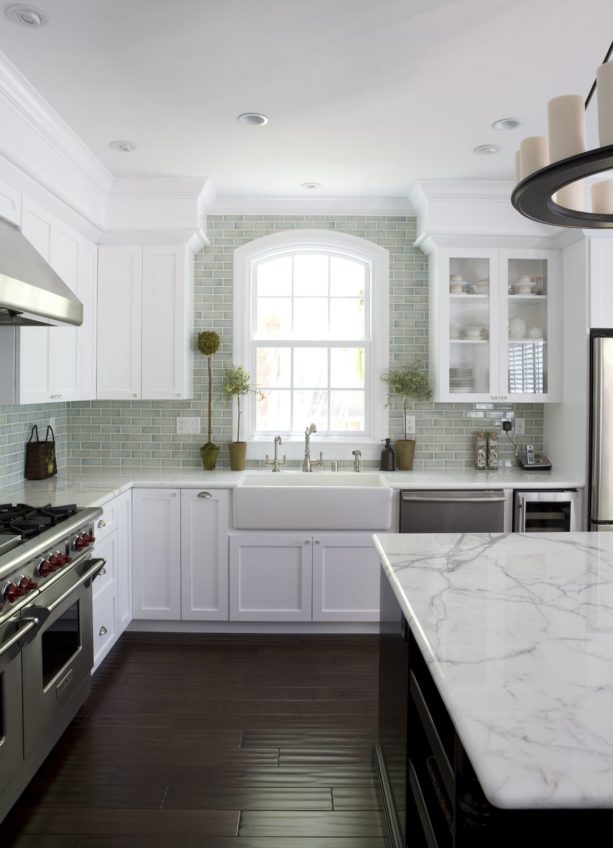 dark hand scraped hardwood floor paired with white carrara marble tops and cabinets