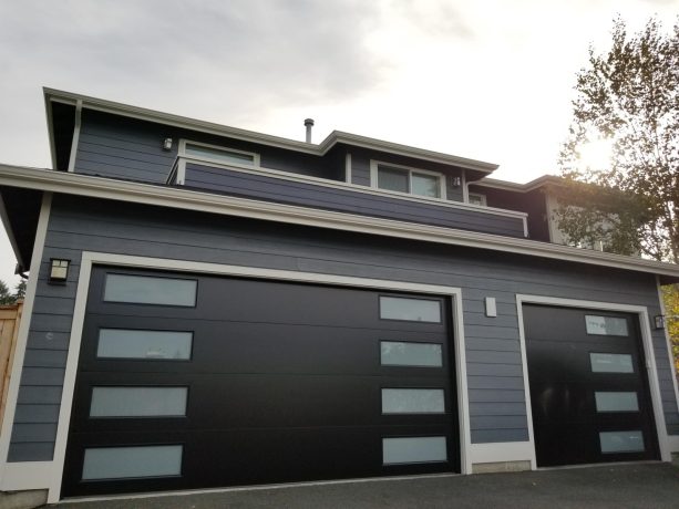 mid-century black colored garage doors with vertical window stack
