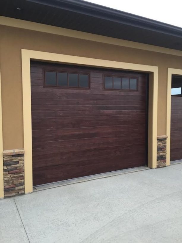 one-car mid-century garage doors made of mahogany with double window panes