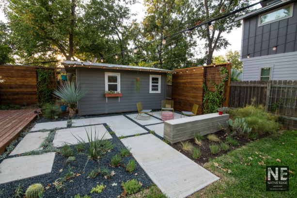 small yet stylish modern backyard poured concrete patio with a cedar plank backdrop